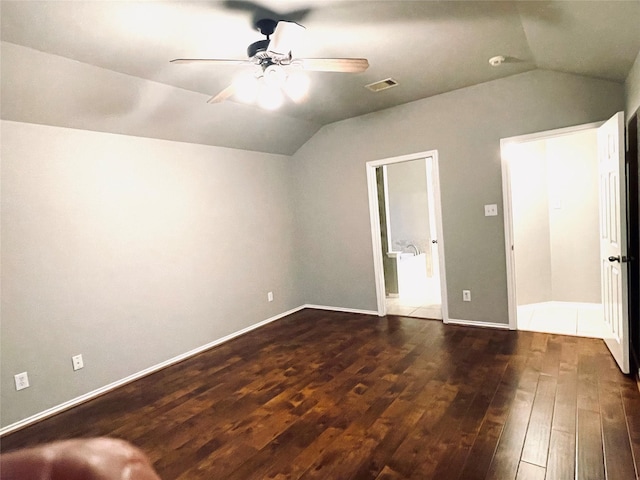 unfurnished bedroom with dark hardwood / wood-style flooring, vaulted ceiling, and ceiling fan