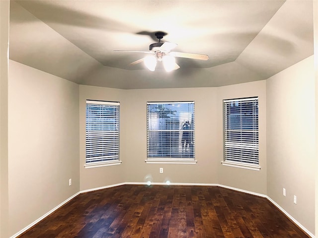 unfurnished room with ceiling fan and dark hardwood / wood-style flooring