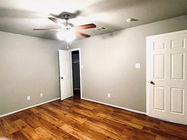 spare room with ceiling fan and dark wood-type flooring