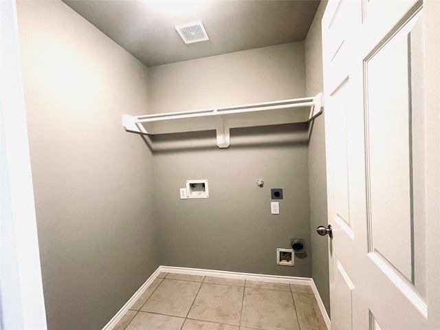 washroom featuring washer hookup, hookup for a gas dryer, light tile patterned floors, and electric dryer hookup