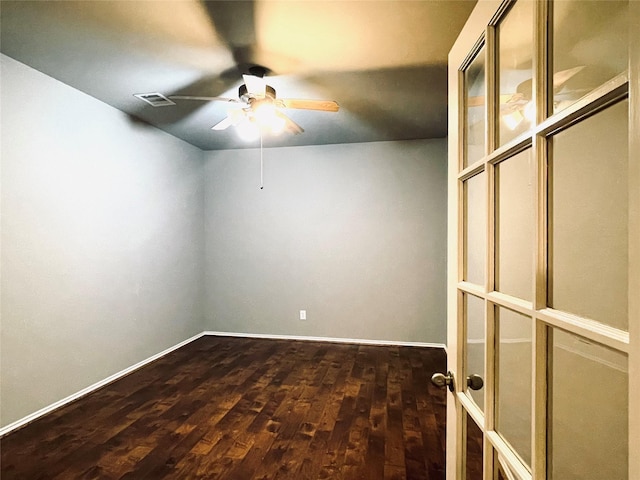 spare room with ceiling fan and dark wood-type flooring