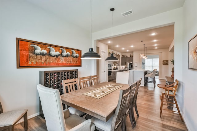 dining space with light hardwood / wood-style flooring