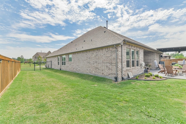 rear view of house featuring a lawn and a patio