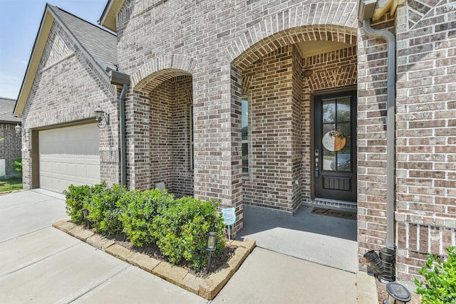 doorway to property with a garage