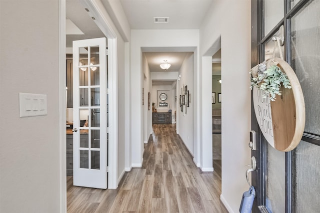 hallway featuring light hardwood / wood-style flooring