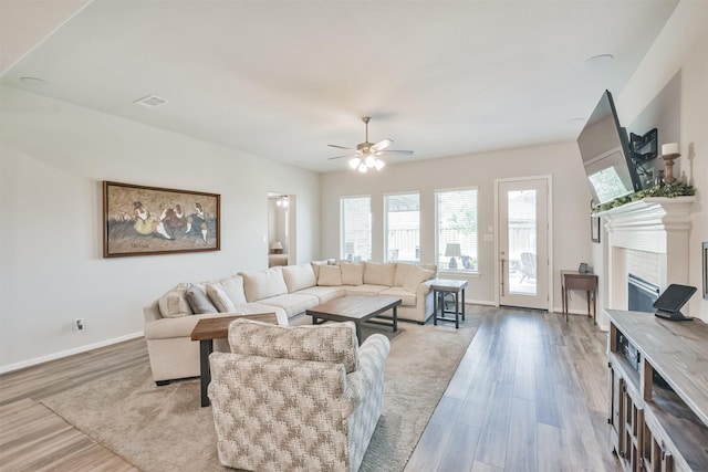 living room with light wood-type flooring and ceiling fan