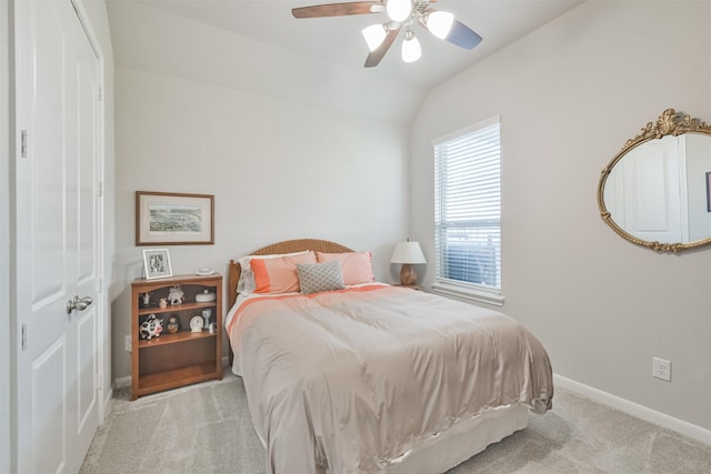 bedroom with ceiling fan, light carpet, and lofted ceiling