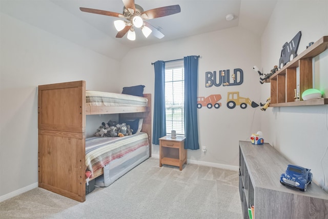 bedroom with ceiling fan, light carpet, and vaulted ceiling