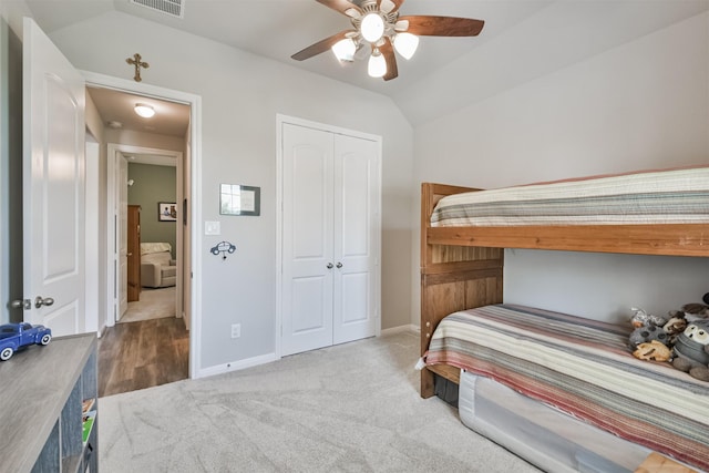 bedroom featuring carpet flooring, ceiling fan, lofted ceiling, and a closet