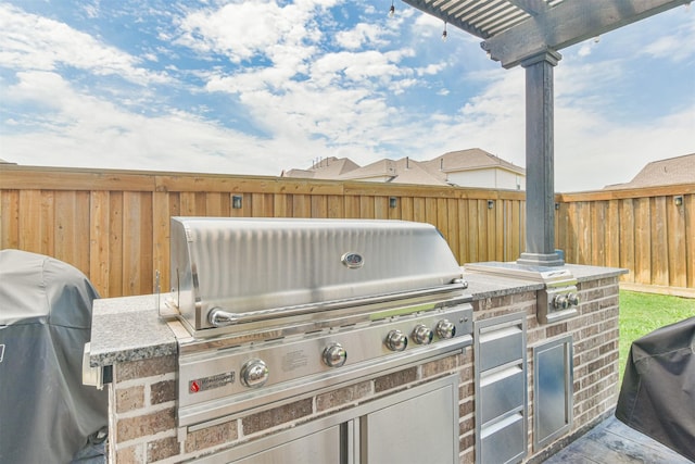 view of patio / terrace with an outdoor kitchen and a grill