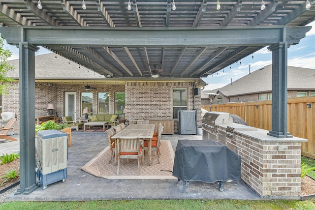 view of patio featuring an outdoor hangout area, ceiling fan, area for grilling, and an outdoor kitchen