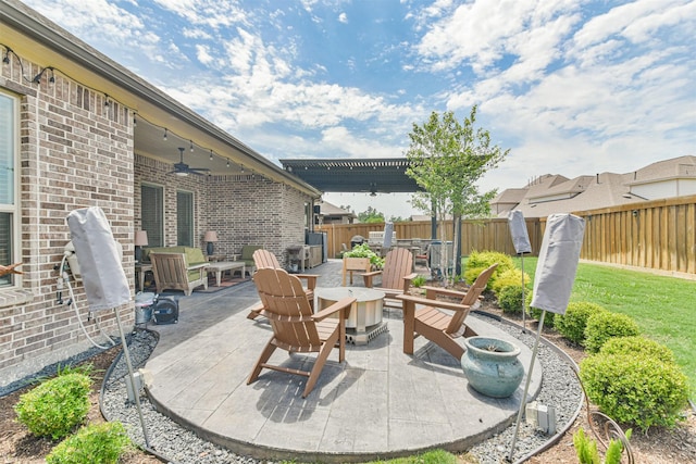 view of patio with ceiling fan and an outdoor fire pit