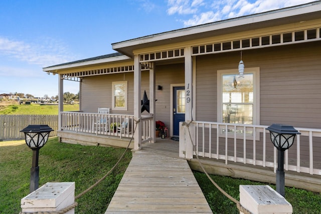 property entrance featuring a lawn