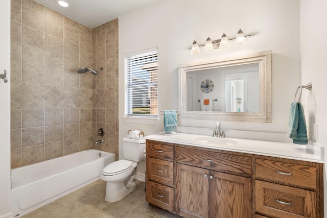 full bathroom featuring vanity, tiled shower / bath combo, and toilet