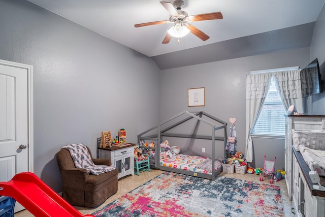 tiled bedroom featuring vaulted ceiling and ceiling fan