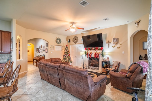 tiled living room with ceiling fan