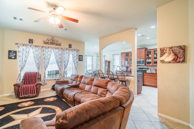 living room featuring ceiling fan and light tile patterned flooring