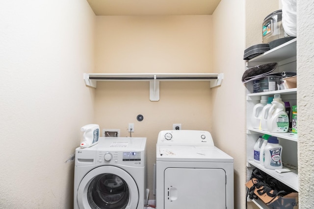 clothes washing area with washer and clothes dryer