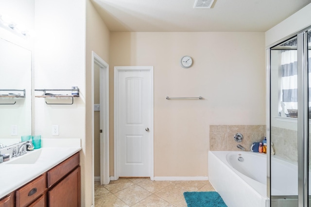 bathroom featuring tile patterned flooring, vanity, and a washtub