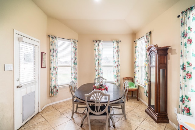 tiled dining area with vaulted ceiling