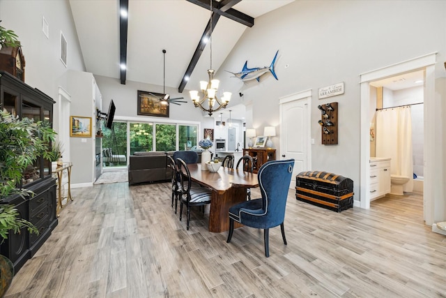 dining area with ceiling fan, beam ceiling, light wood-type flooring, and high vaulted ceiling