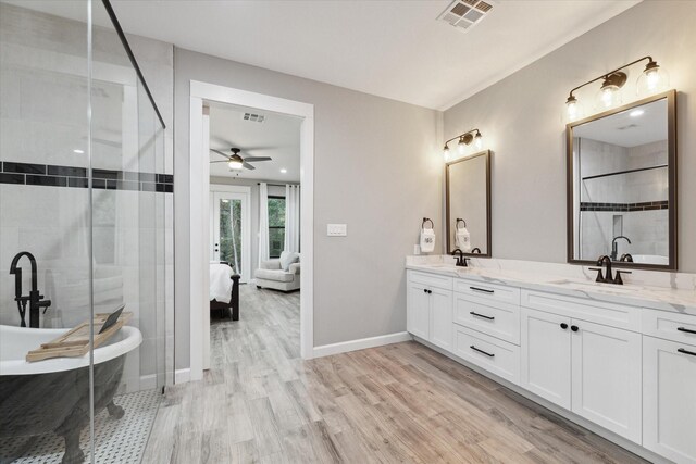 bathroom with separate shower and tub, ceiling fan, vanity, and wood-type flooring