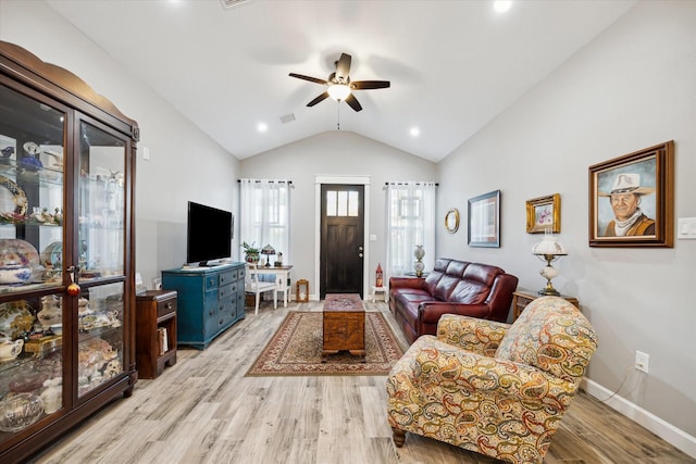 living room with ceiling fan, light wood-type flooring, and lofted ceiling