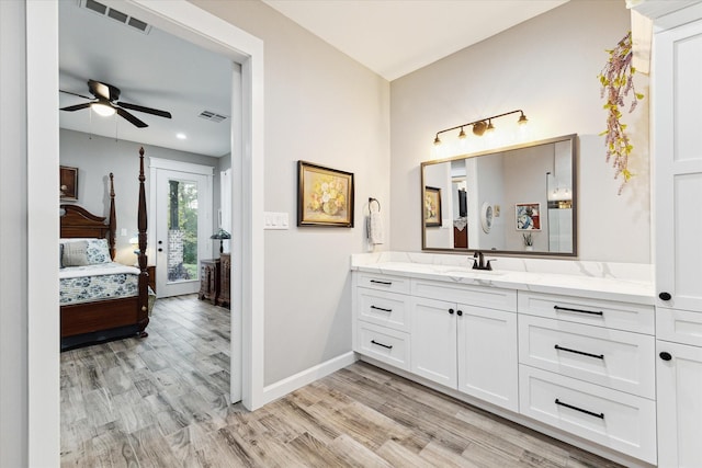 bathroom featuring ceiling fan, wood-type flooring, and vanity