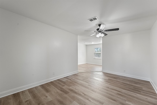 spare room featuring wood-type flooring and ceiling fan