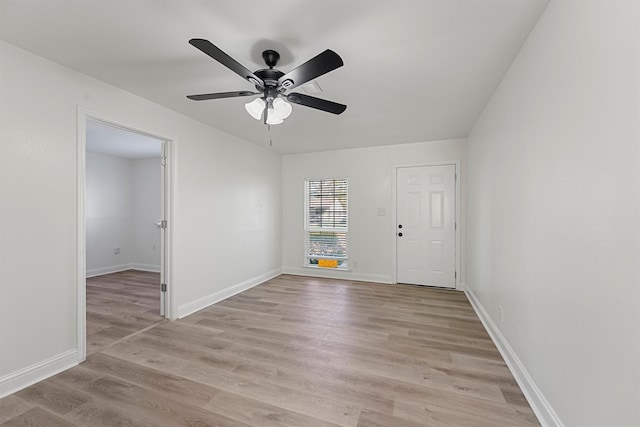 empty room with light wood-type flooring and ceiling fan