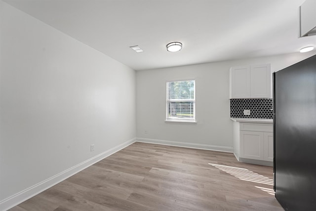 unfurnished dining area featuring light hardwood / wood-style flooring