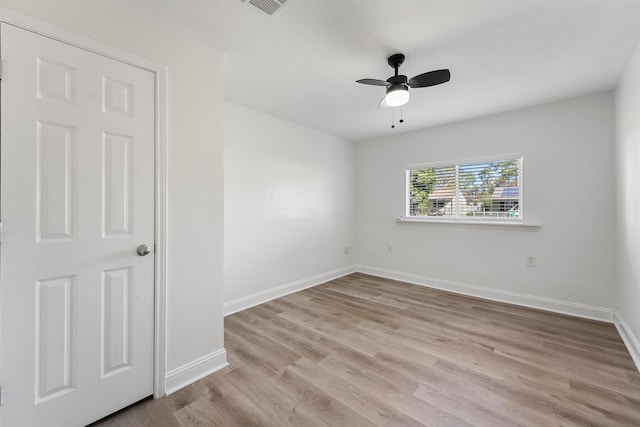 empty room featuring light wood-type flooring and ceiling fan