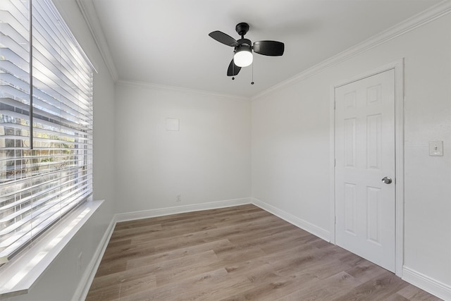 empty room with crown molding, ceiling fan, and light hardwood / wood-style floors