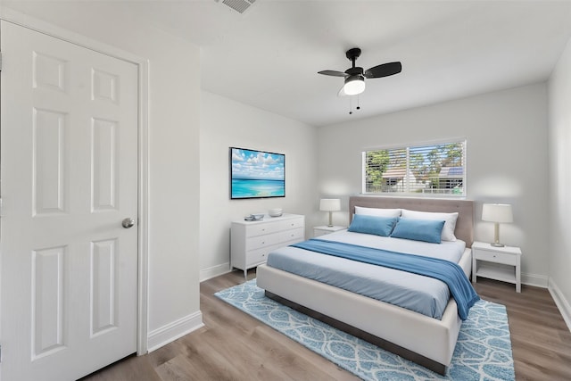 bedroom featuring hardwood / wood-style floors and ceiling fan