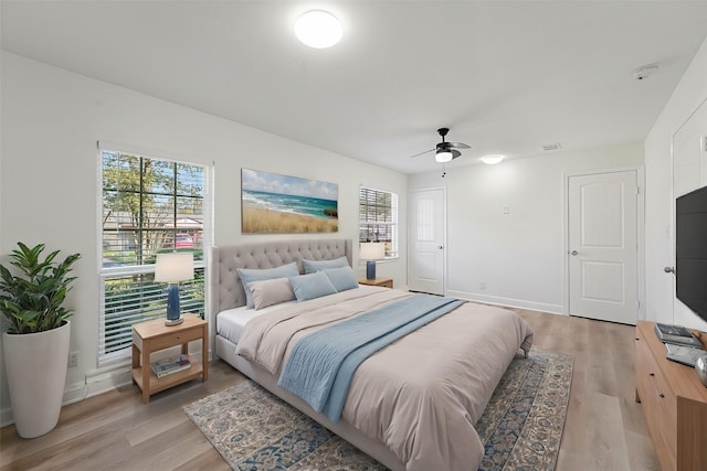 bedroom with ceiling fan and light wood-type flooring