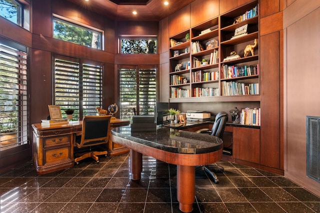 office area with built in shelves and a high ceiling