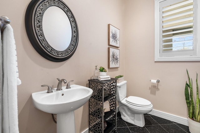 bathroom with tile patterned flooring, toilet, and sink