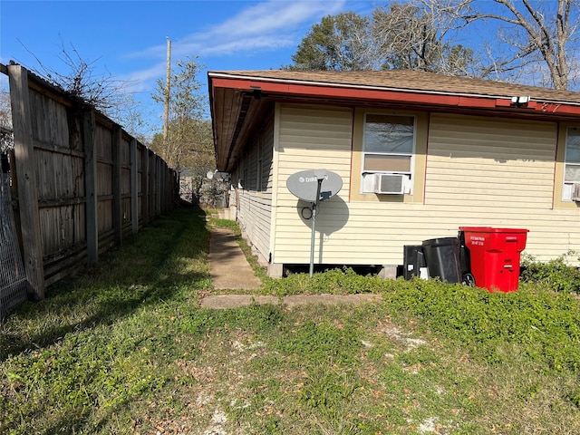 view of property exterior with a lawn and cooling unit