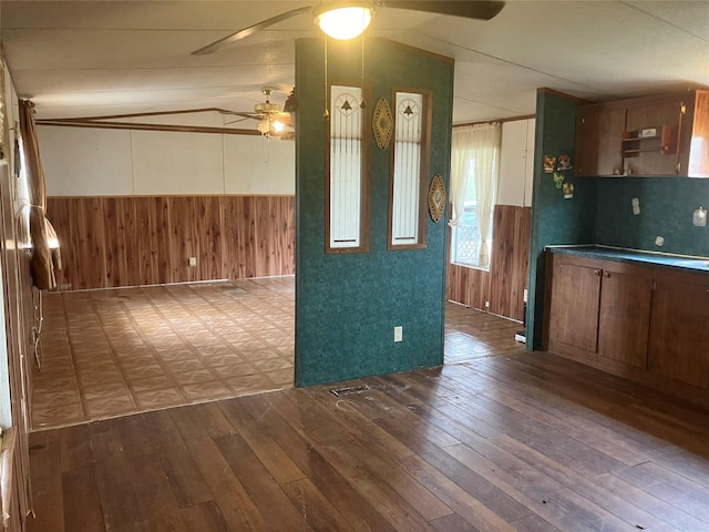 kitchen with wooden walls and light hardwood / wood-style flooring