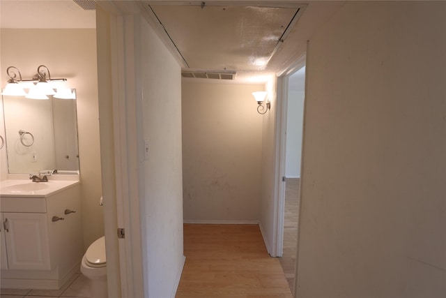 bathroom with vanity, hardwood / wood-style flooring, and toilet