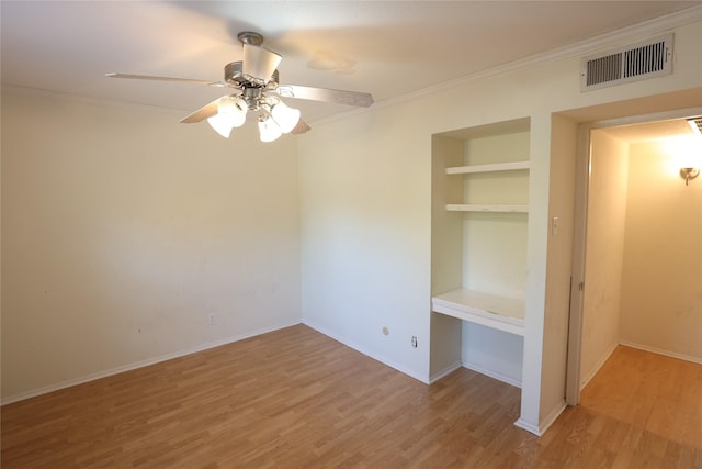 unfurnished bedroom with wood-type flooring, a closet, ceiling fan, and crown molding