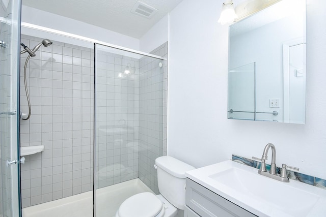 bathroom featuring vanity, toilet, and a shower with door