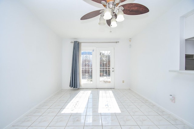 spare room featuring ceiling fan and french doors