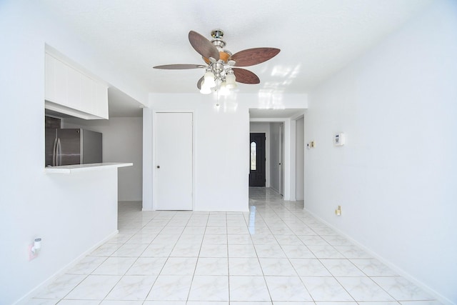 empty room with a textured ceiling and ceiling fan