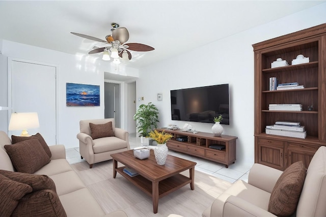 tiled living room with ceiling fan