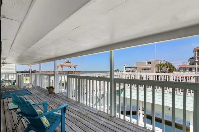 deck with a gazebo and a water view