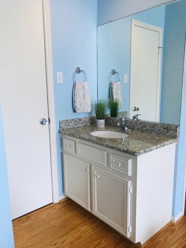 bathroom with vanity and hardwood / wood-style flooring