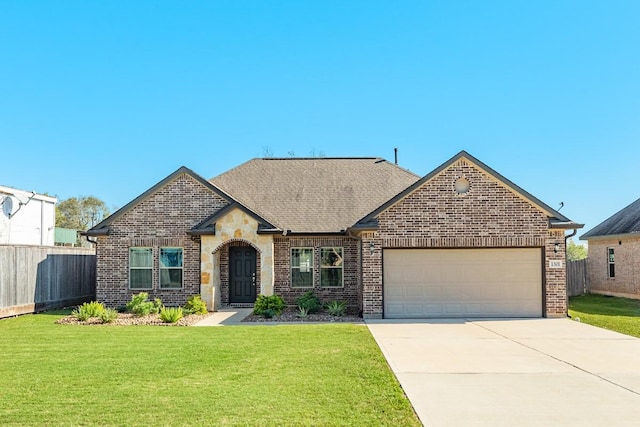 view of front of property with a garage and a front lawn