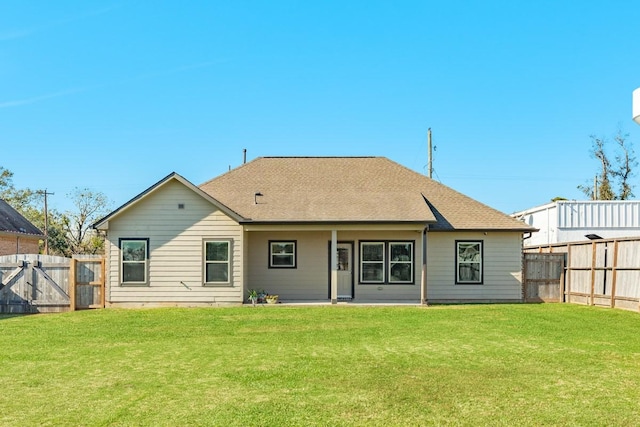 back of property with a lawn and a patio area