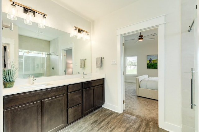 bathroom featuring hardwood / wood-style floors, vanity, ceiling fan, and a shower with shower door